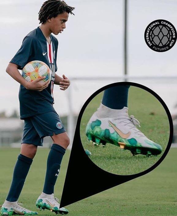 Ethan Mbappe wearing boots designed by his brother, Kylian Mbappe.